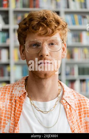 A man in glasses and checkered shirt ponders in thought. Stock Photo