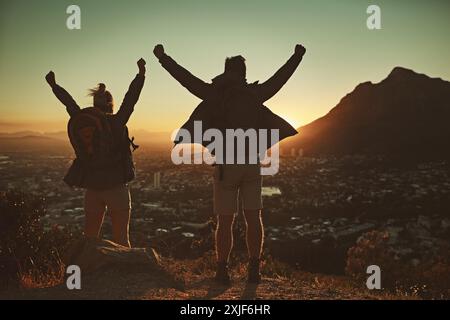 Couple, hiking and freedom on mountain outdoor for peak triumph, trekking and activity on travel journey. Man, woman and back view on cliff with Stock Photo