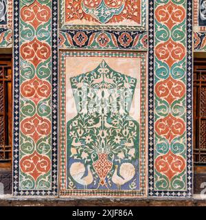 Detailed floral design on Shaki Khan's Palace exterior wall in Azerbaijan. Intricate pattern with leaves, flowers, birds in vibrant colors on white Stock Photo