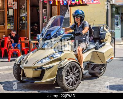 Expensive BRP "City Bike 3B" 3-wheel motorcycle cruising through city center - Chatellerault, Vienne (86), France. Stock Photo
