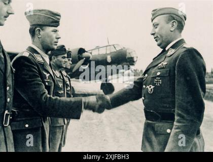 A photograph captures Major R. awarding a Croatian soldier the Iron Cross during Operation Barbarossa in 1941. The Croatian forces, aligned with Nazi Germany after the Axis invasion of Yugoslavia, played a significant role in supporting the German advance against Soviet forces on the Eastern Front. Stock Photo