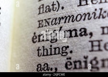 Word enigma on dictionary page, macro close-up Stock Photo