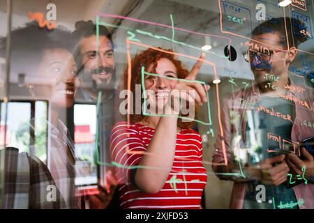 Team of programmers writing digital code in the metaverse and working together on the internet Stock Photo