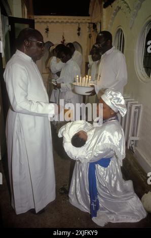 Christening Baby Naming Ceremony 1990s UK. Celestial Church of Christ London Child being blessed being held by a Spirit Medium, black British church service. Elephant and Castle, London, England, 1993 1990s UK HOMER SYKES. Stock Photo