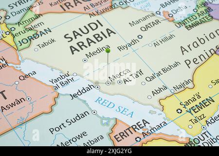 Close up to a Mecca city with a green pin needle into Saudi Arabia country political map Stock Photo