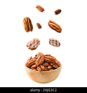 Pecan nuts falling into bowl on white background Stock Photo