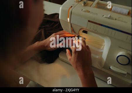 Tailor Using Sewing Machine At His Work Stock Photo