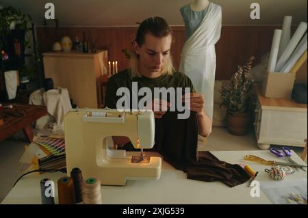 Designer Working With Clothes On Machine Stock Photo