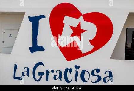 Blue - red combination of a sign I Love La Graciosa, written on a shuttle boat to the island. White background. Lanzarote - La Graciosa, Canary Island Stock Photo