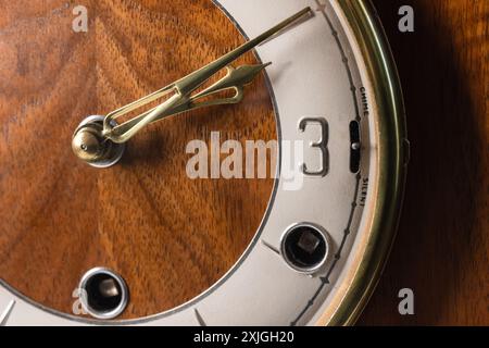 Vintage chiming mantel clock details, close up photo of white clock face with Arabic number 3 Stock Photo