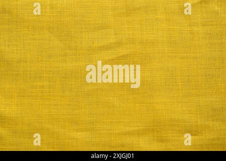 Texture of yellow linen fabric closeup as textile background Stock Photo