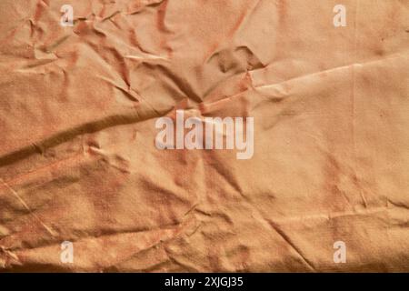 Silk golden crumpled fabric texture closeup as textile background Stock Photo