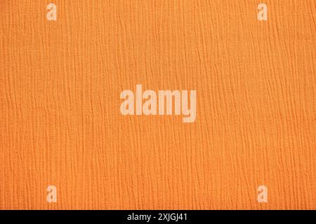 Creped orange fabric closeup as textile background Stock Photo