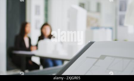Specialists at creative agency gather data on plans and determine real scale dimensions to guarantee that the building crew gets correct items. Architects researching 3D printed structures. Stock Photo