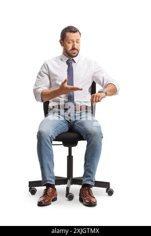 Professional man sitting in an office chair and checking time on watch isolated on white background Stock Photo