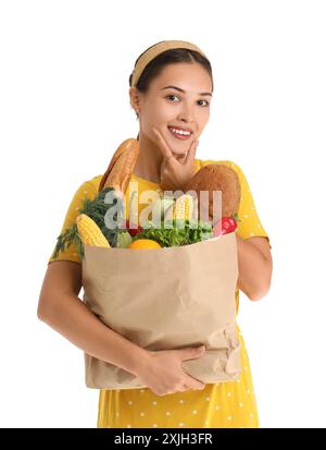 Beautiful young Asian woman with paper bag full of fresh products isolated on white background Stock Photo