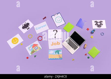 Paper sheets with word JOB, question mark, laptop and child psychologist's items on lilac background, top view Stock Photo