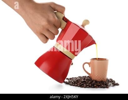 Woman pouring espresso from geyser coffee maker into cup on white background Stock Photo