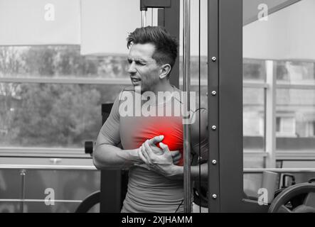 Man suffering from heart pain in gym Stock Photo