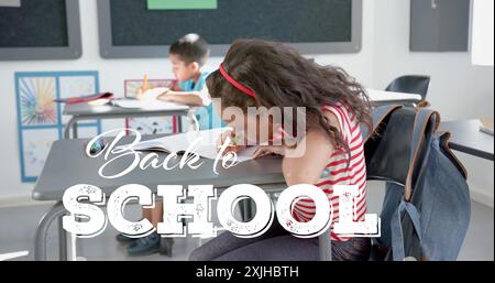 Back to school text over children studying in classroom, image. Education, learning, students, school supplies, notebooks, teaching Stock Photo