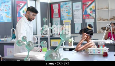Scientist conducting experiment over image of molecular structures in classroom Stock Photo