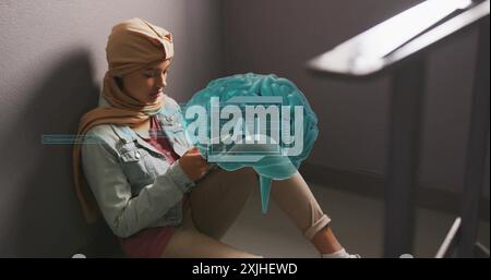 Image of ai text and data over biracial female student in hijab with tablet. Global artificial intelligence, connections, computing and data processin Stock Photo