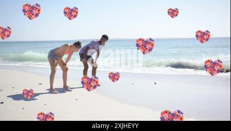 Image of hearts moving over diverse couple in love on beach in summer. Love, romance, valentine's day and vacation concept digitally generated image. Stock Photo