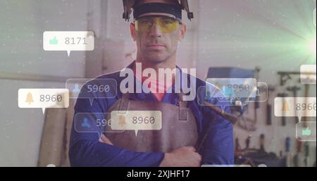 Social media likes and follower count image over industrial worker in workshop. Technology, followers, industry, factory, digital, engagement Stock Photo