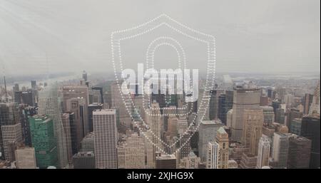 Image of padlock and shield icon over modern cityscape. Network, data, security, digital interface, connection, business and communication, digitally Stock Photo