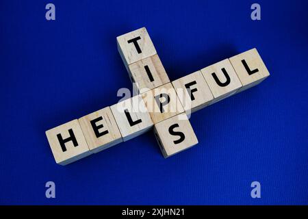 Helpful tips alphabet letters on blue background Stock Photo