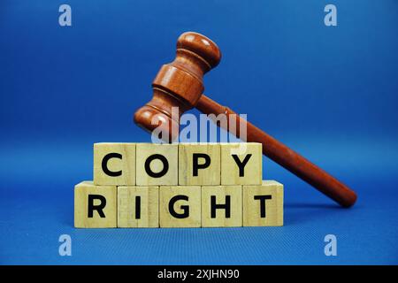 Copy Right alphabet letters with wooden blocks alphabet letters and Gavel on blue background Stock Photo
