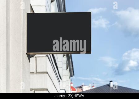 Blank Mock-up Of Restaurant Black Signboard Hanging On A Wall Stock Photo