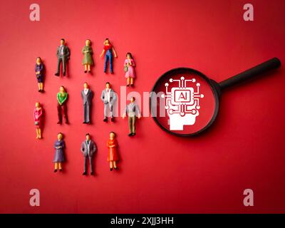 Miniature people and magnifying glass with Ai icon on a red background Stock Photo