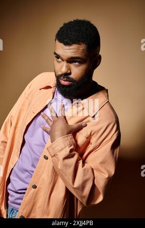 Stylish man with beard in fashionable attire poses confidently. Stock Photo