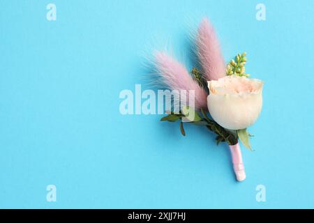 Small stylish boutonniere on light blue background, top view. Space for text Stock Photo