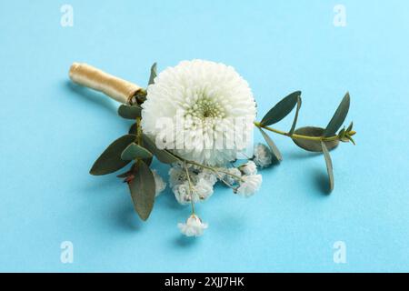 Small stylish boutonniere on light blue background Stock Photo