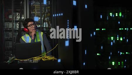 Image of circuit board and data processing over asian male it engineer by computer servers Stock Photo