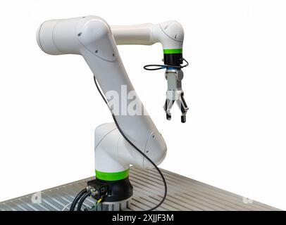 Isolated modern white robotic arm on a conveyor belt.Isolated modern white robotic hand in production. Stock Photo