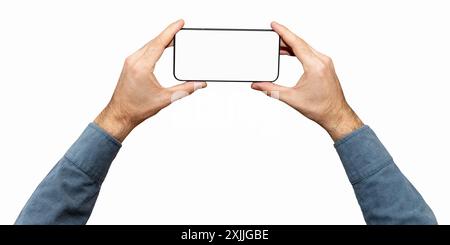 Isolated male's hands with blue sleeves holds mobile phone with empty screen and black frame. Stock Photo