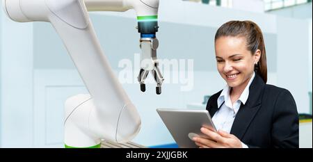 Robotic and autonomous technological solution in manufacturing. A businesswoman analyzes the performance of a robotic arm using her digital tablet. Stock Photo