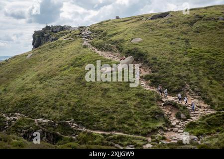 A group of women walkers carry babies and infants and descend the steps from Crowden Tower on the lower stages of the Pennine Way, on 17th July 2024, in Edale, Derbyshire, England. Stock Photo