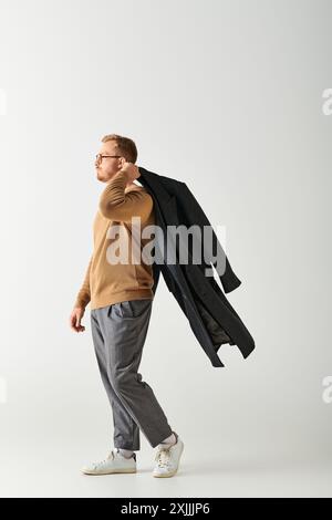 Stylish man walking on white backdrop. Stock Photo
