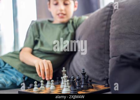 Father and son playing chess at home Stock Photo