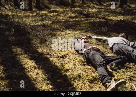 Company of friends spends time outdoors, in the forest. Stock Photo