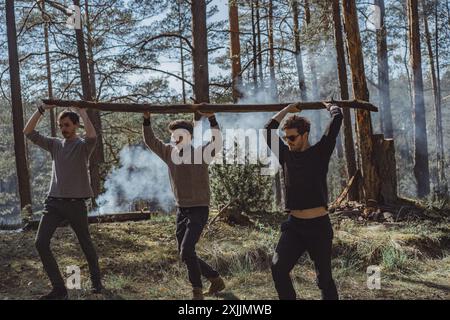 Company of friends spends time outdoors, in the forest. Stock Photo