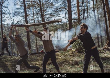 Company of friends spends time outdoors, in the forest. Stock Photo
