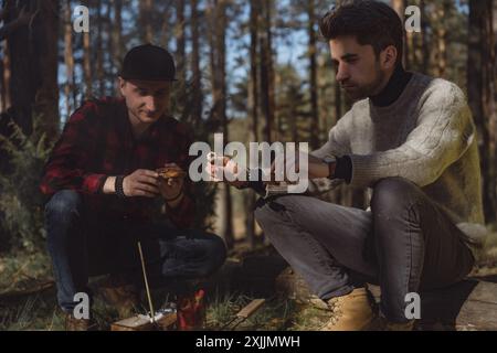 Company of friends spends time outdoors, in the forest. Stock Photo