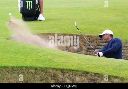 USA's Tiger Woods chips out of a bunker on the 5th during day two of The Open at Royal Troon, South Ayrshire, Scotland. Picture date: Friday July 19, 2024. Stock Photo