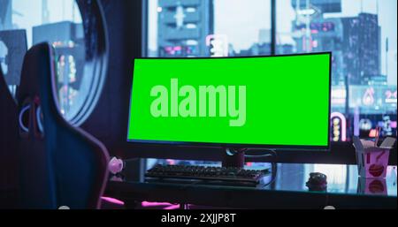 Professional Video Game Computer with Green Screen Mock Up Display Standing on a Stylish Table in a Futuristic Cyberpunk Room with Neon Light Stock Photo