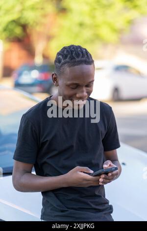 young black man using his smartphone Stock Photo